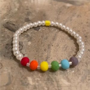5 1/2”-5 3/4” wrist. 6mm Rainbow w/ 4mm white pearl glass bead stretch bracelet.